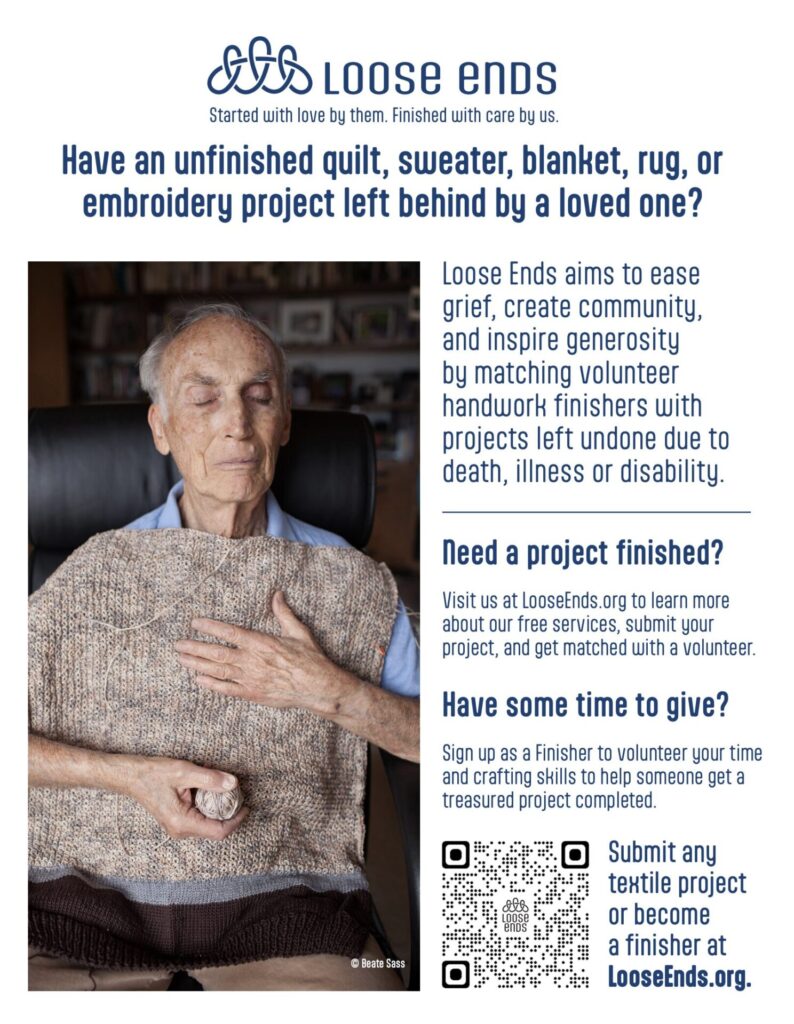 Elderly man with eyes closed, resting in a chair, wearing a beige knit sweater.