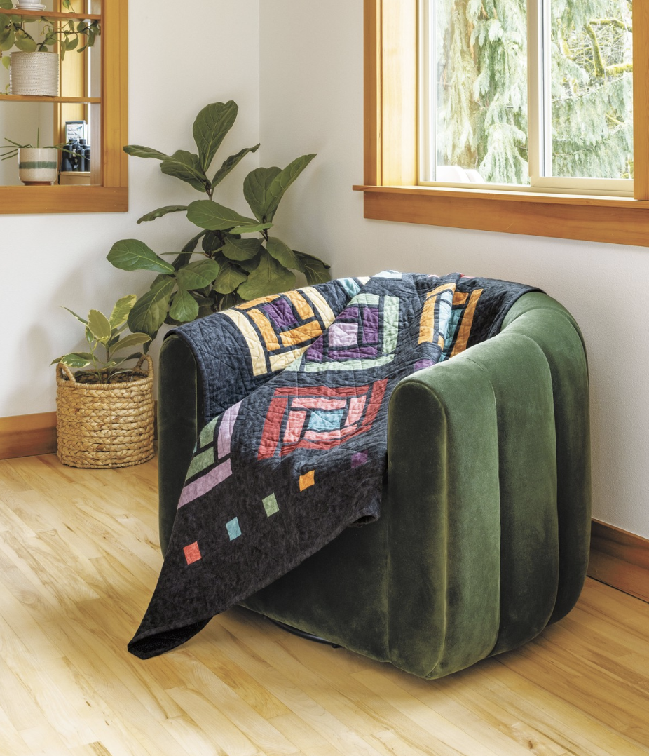 Cabin Windows - quilt draped across a chair